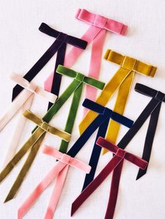 several different colored ties laid out on top of each other, with one tied in the middle