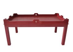 a red tray that is on top of a wooden table with one drawer and two legs