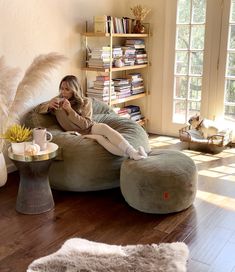 a woman sitting on a bean bag chair in a living room