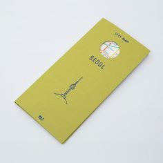 a yellow travel book with the words seoul on it