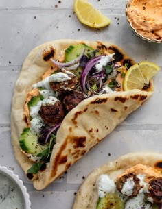 two pita breads filled with meat and vegetables