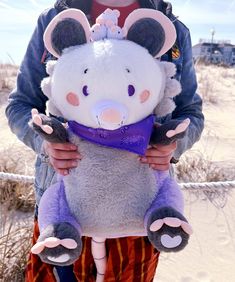 a person holding a stuffed animal in their hands