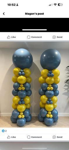 two tall blue and yellow balloons in front of a white wall