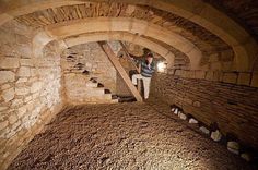 a man is climbing up the stairs in an old stone building with cobblestones