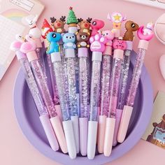 a purple plate topped with lots of different types of pens