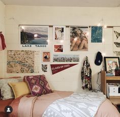 a bedroom with many pictures on the wall