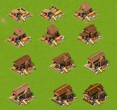 a bunch of small wooden buildings on a green field