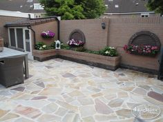 an outdoor patio with potted plants and flowers