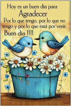 two blue birds sitting on top of a bucket filled with flowers and daisies in spanish