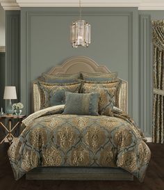 a bed in a room with a chandelier and pillows on the headboard