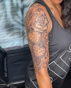 a woman with a rose and clock tattoo on her arm is looking at the camera