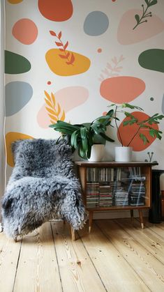 a living room with a plant and wallpaper