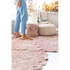 a woman standing on top of a pink rug