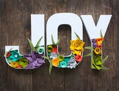 the word joy is made out of paper flowers