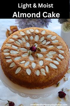 a cake with almonds on top and the words light & moist almond cake above it