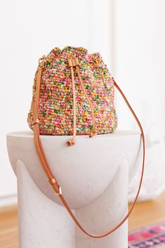 a bag with sprinkles on it sitting on top of a white pedestal