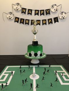 a birthday cake with soccer players on it