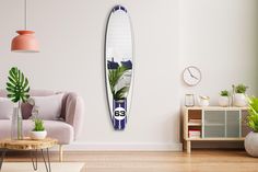 a living room with a surfboard on the wall