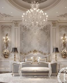 an elegant bedroom with chandelier and white furniture