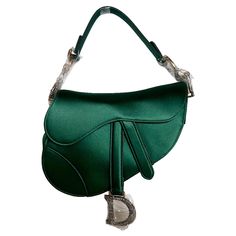 Dior Saddle Mini 2019 Silk Emerald Green with crystals These are professional photos of the actual bag. 2019 Dior Saddle bag, crafted in Emerald Green silk satin, the legendary design comes in size mini, features a magnetic flap, and bedazzling crystal embellished CD signature on both sides of the strap. The Saddle bag may be carried by hand. The silk saddle design is extremely classy, and the emerald green is a stunning color. CONDITION: MINT DETAILS Christian Dior Saddle Size: Mini Dimensions: Dior Green Bag, Emerald Green Clothes, Saddle Design, Green Bags, Expensive Bag, Hermes Kelly Bag, Ariana Grande Style, Dior Saddle, Professional Photos