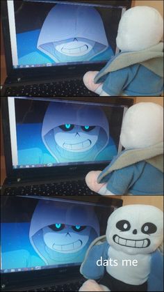 the stuffed toy is sitting in front of two computer monitors with blue eyes and an angry face