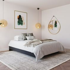 a bed sitting in a bedroom next to two hanging lights