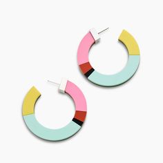 a pair of colorful hoop earrings on a white background