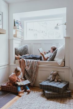 two children are reading books on the bed in their room with stuffed animals and pillows