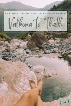 a person laying on top of a large rock next to a river with the words, the most beautiful hike in albania val