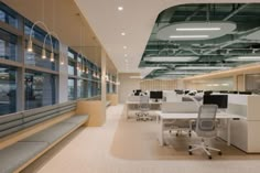 an empty office with lots of desks and chairs in it's center area