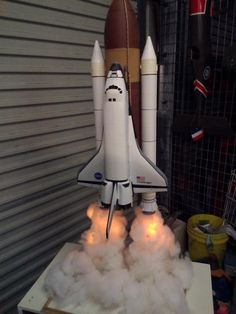 a model space shuttle is on display in a garage