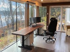 a home office with large windows overlooking the water