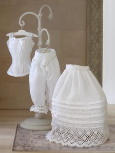 a white dress and skirt on display in front of a mirror