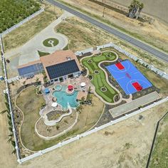 an aerial view of a basketball court and pool in the middle of a desert area