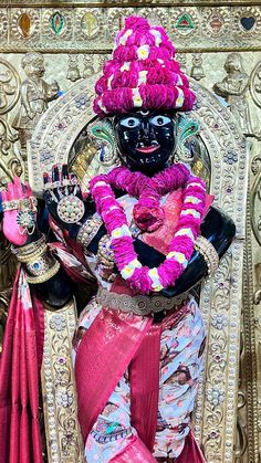 an idol is displayed in front of a wall