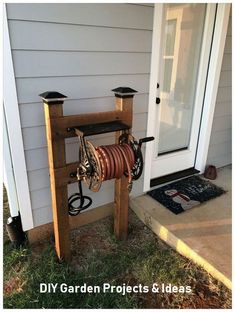 a wooden stand with two hoses attached to it in front of a white door