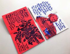 two red and white cards with blue writing on the front one has an image of a woman holding flowers