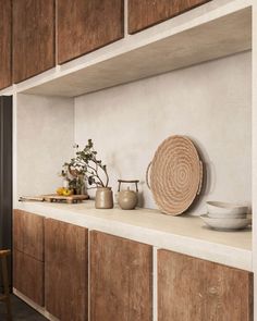 a kitchen with wooden cabinets and plates on the counter top in front of an empty chair