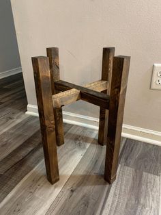 a wooden chair sitting on top of a hard wood floor next to a light switch