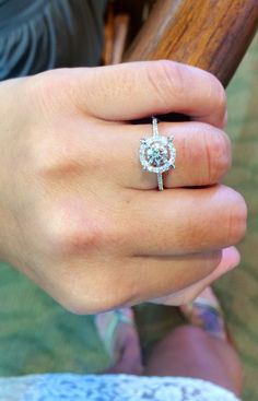 a close up of a person's hand with a ring on it