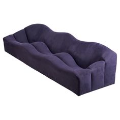 a purple couch sitting on top of a white floor