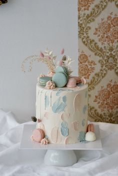 a white cake with blue and pink decorations