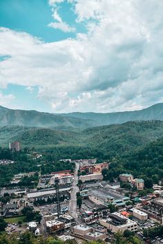 an aerial view of a city with mountains in the background