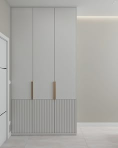 an empty room with white walls and cupboards