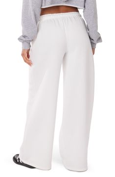 Let 'em know you're here for the drama in cotton-blend sweatpants fashioned with a low rise and wide leg. 50% cotton, 50% polyester Machine wash, line dry Imported White Baggy Wide-leg Sweatpants, Wide-leg Sweatpants For Spring, White Wide Leg Pants With Elastic Waistband, White High-waisted Wide Leg Cotton Pants, White High-waisted Cotton Wide Leg Pants, Spring High-waisted Sweatpants With Comfort Waistband, White Relaxed Fit Bottoms For Fall, Wide Leg Pants With Comfort Waistband And Relaxed Fit, Wide Leg Sweatpants For Fall