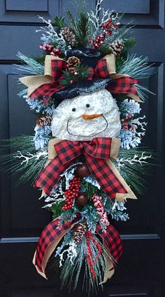 a snowman wreath hanging on the front door