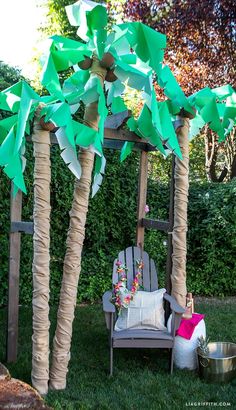 some paper palm trees and a chair in the grass