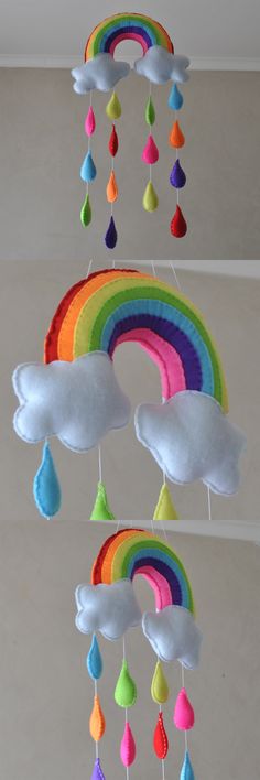 a rainbow mobile hanging from the ceiling with raindrops and drops on it's sides