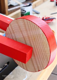 a red piece of wood sitting on top of a table