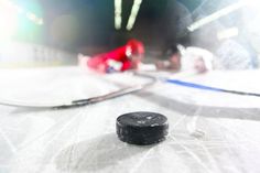 an ice hockey puck sitting on top of a rink